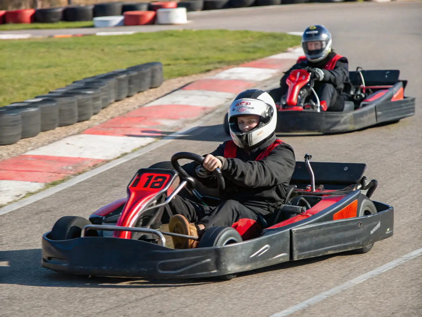 A dynamic shot of RUAL RACING participants engaged in a training session, focusing on precision driving techniques on a slalom course. The image captures the intensity and focus of the drivers as they navigate the course.